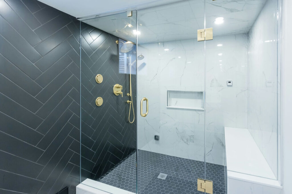 combination of zig zag tiles and hexagon tile for shower unit and golden faucets