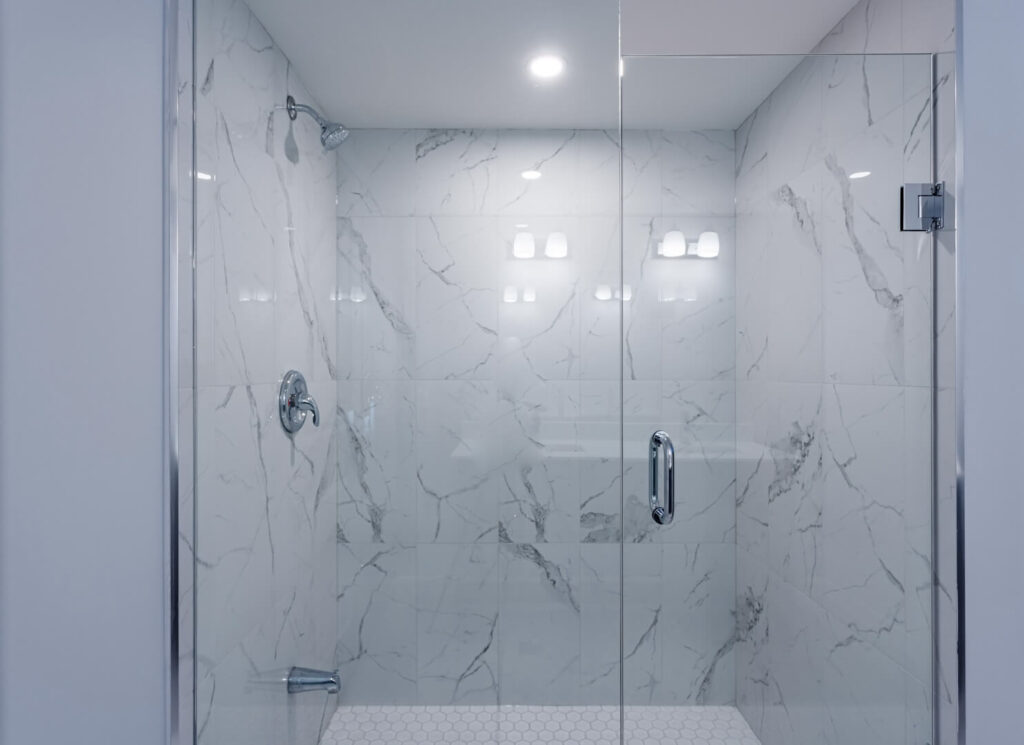 marble tiled bathroom walls with glass door