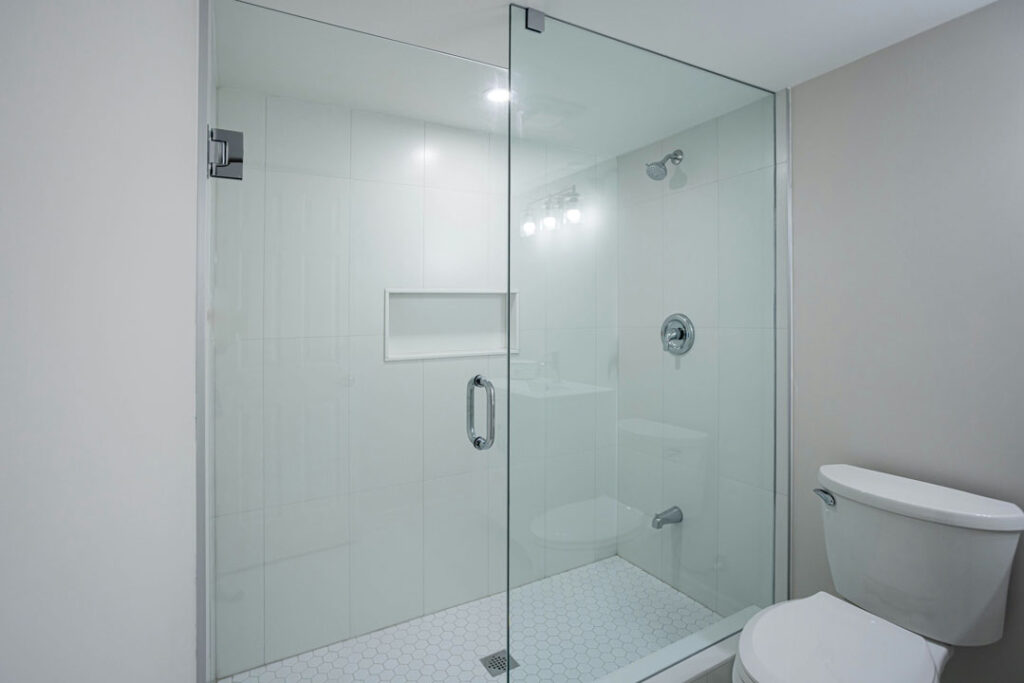 shower unit glass door with handle and tiled wall
