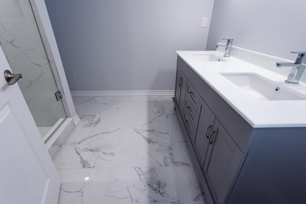 bathroom marble flooring with grey vanity and countertop