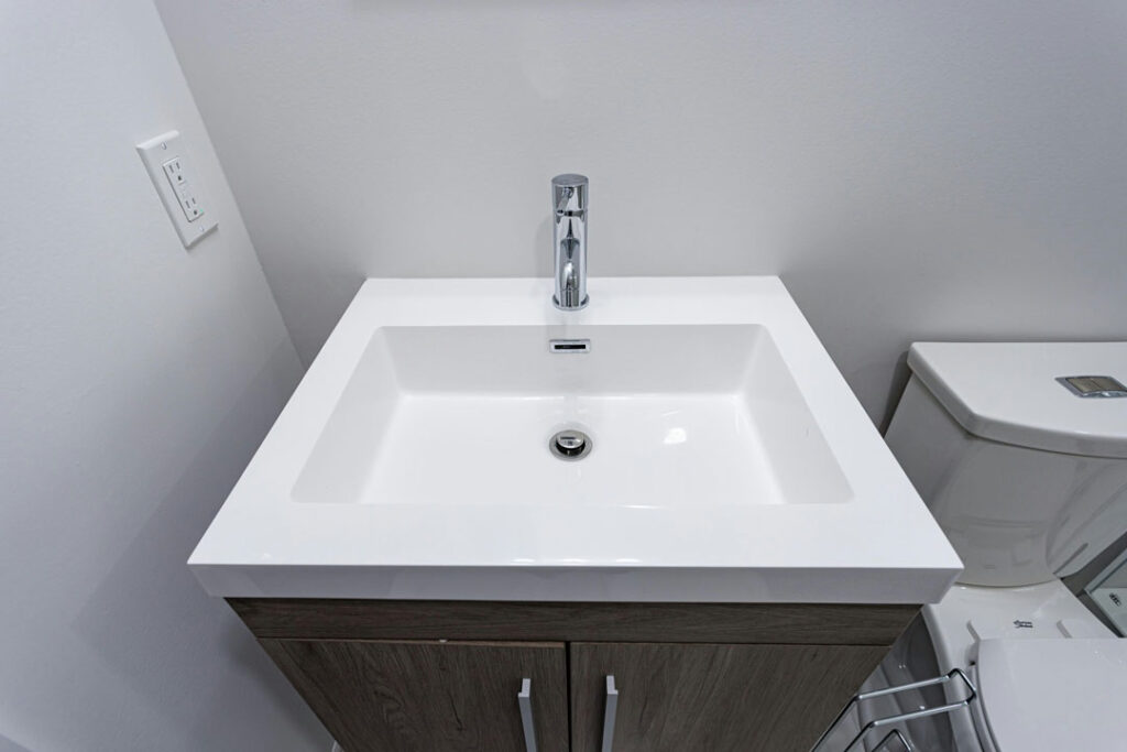 modish bathroom vanity with countertop and basina and faucets