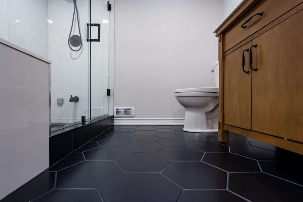 Modern Basement Bathroom Renovation with black hexagon floor tiles
