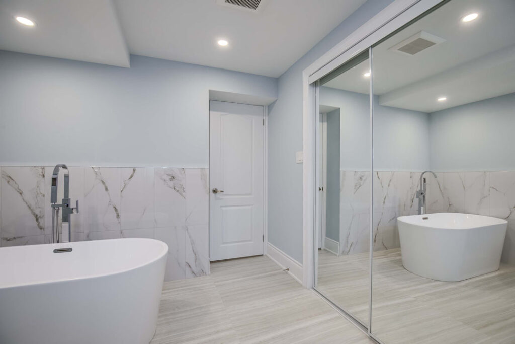 basement bathroom remodel half tiled walls with marble flooring and bath tub